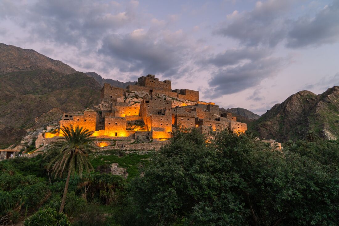 Thee Ain Heritage Village, Saudi Arabia with the lights on at dusk, Saudi Arabia