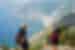 Two travellers hiking on the Path Of The Gods with a great view of the boats and village on Amalfi Coast