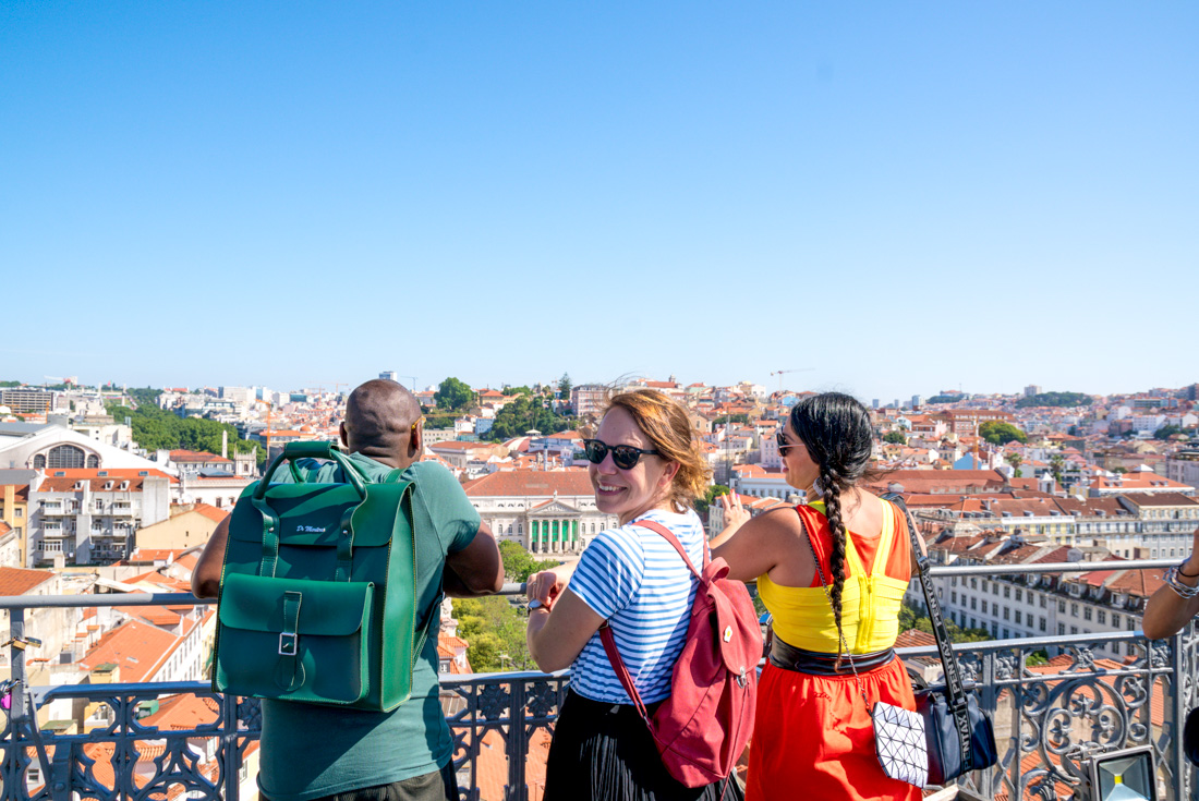 Intrepid travellers look out over Lisbon and smile back on a sunny day in Portugal