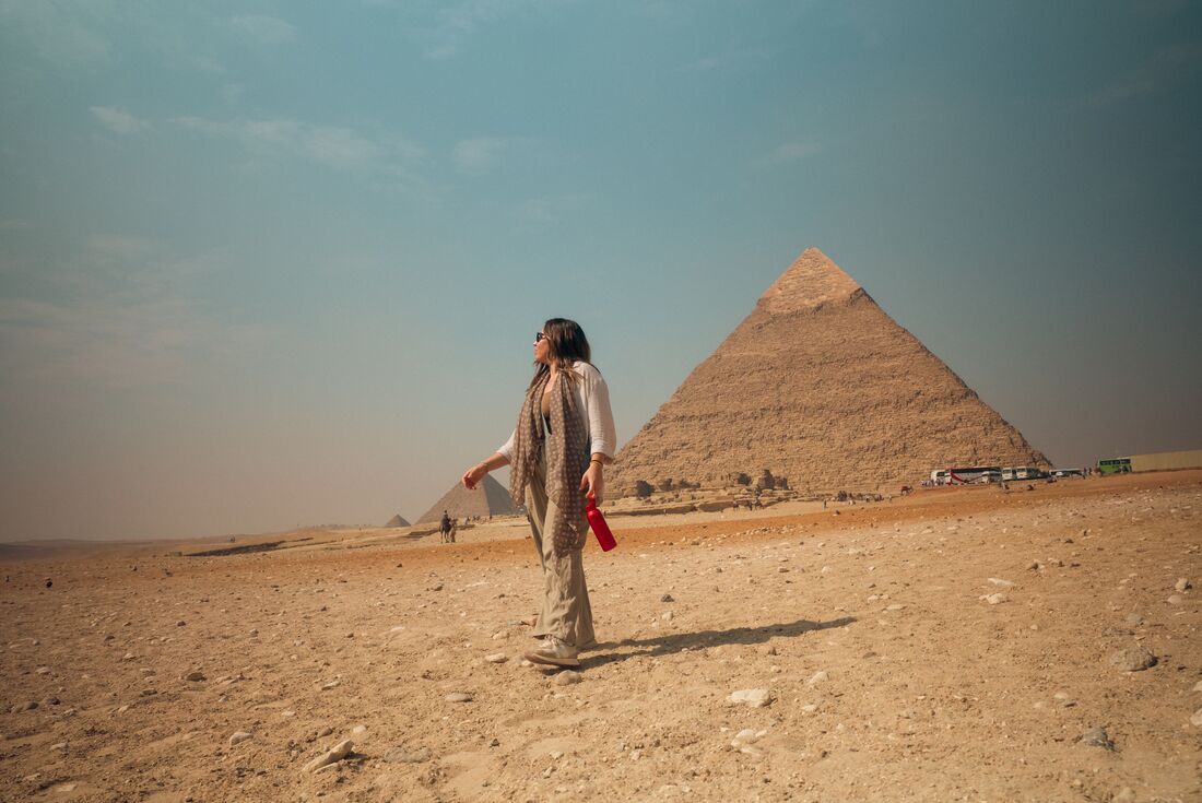 Traveller walking by the Great Pyramids of Giza