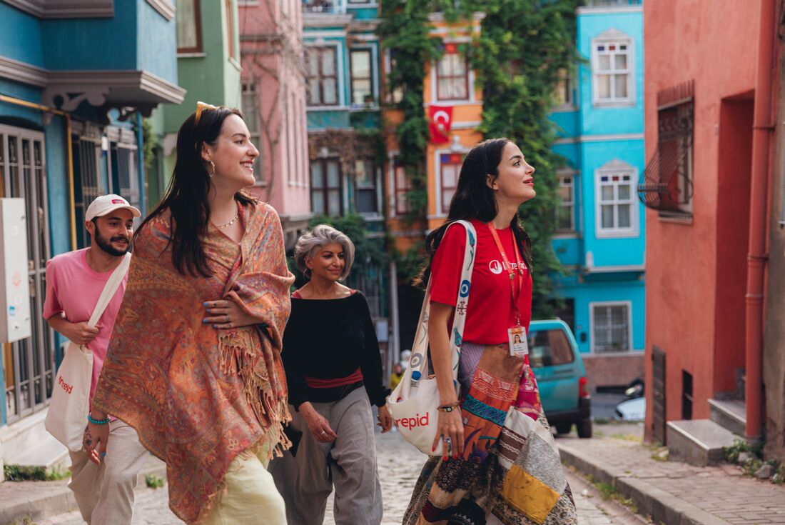 Leader and travellers exploring the colourful streets of Balat district, Istanbul
