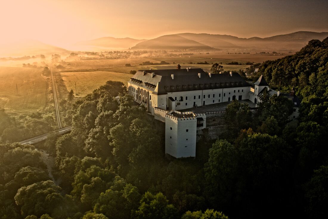 Hotel Grand Viglas perched on a forested hilltop at sunrise overlooking Banksa Stiavnica in Slovakia