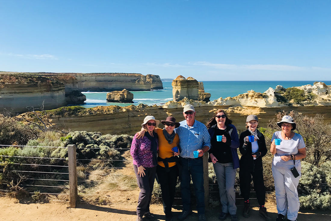 Group of travellers in front of the Twelve Apostles on Great Ocean Road