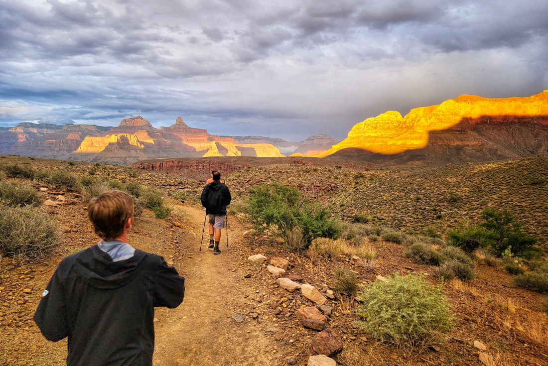 Intrepid travellers hike across a plateau in the depths of the Grand Canyon in Arizona USA