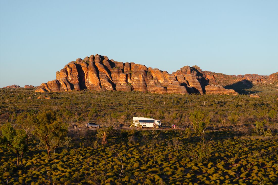 Aerial view of bus and Bungle Bungle range in the background, Purmululu National Park, Western Australia