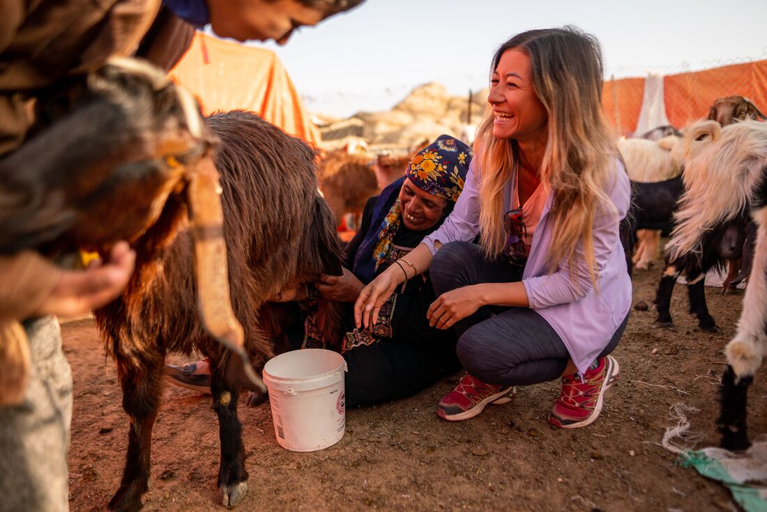 Traveller and local getting fresh milk for breakfast in the Bedouin Camp in Jordan near Wadi Rum