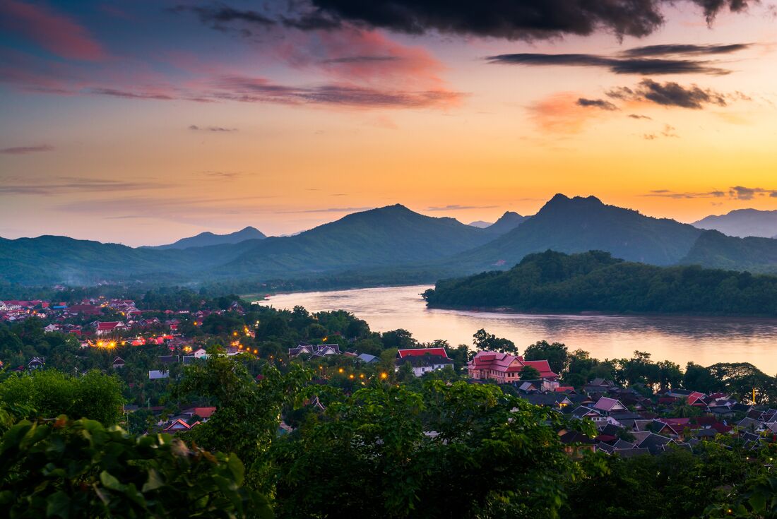 The sun sets behind Mount Phousi over Luang Prabang in Laos
