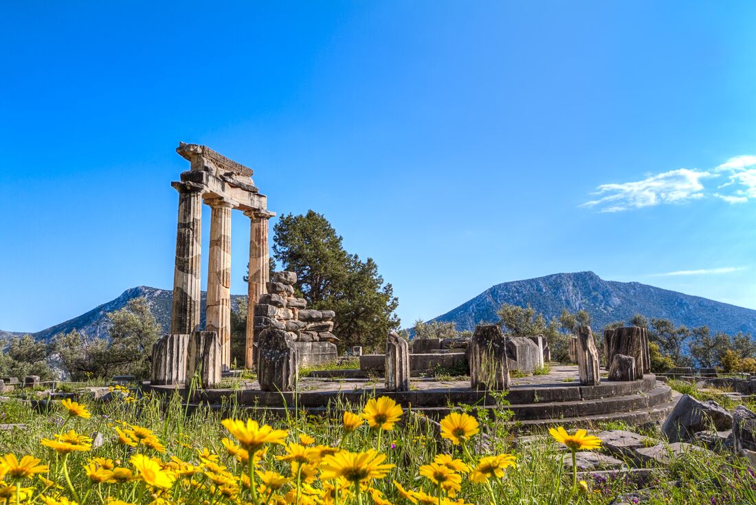 Temple of Athena ruins with stone wall in Delphi, Greece