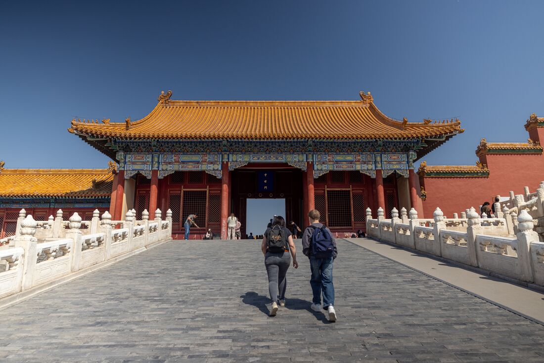 Two travellers walking towards the Gate of Supreme Harmony in the Forbidden City, Beijing, China