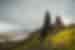 Travellers look up at the towering Old Man of Storr on the Isle of Skye in Scotland