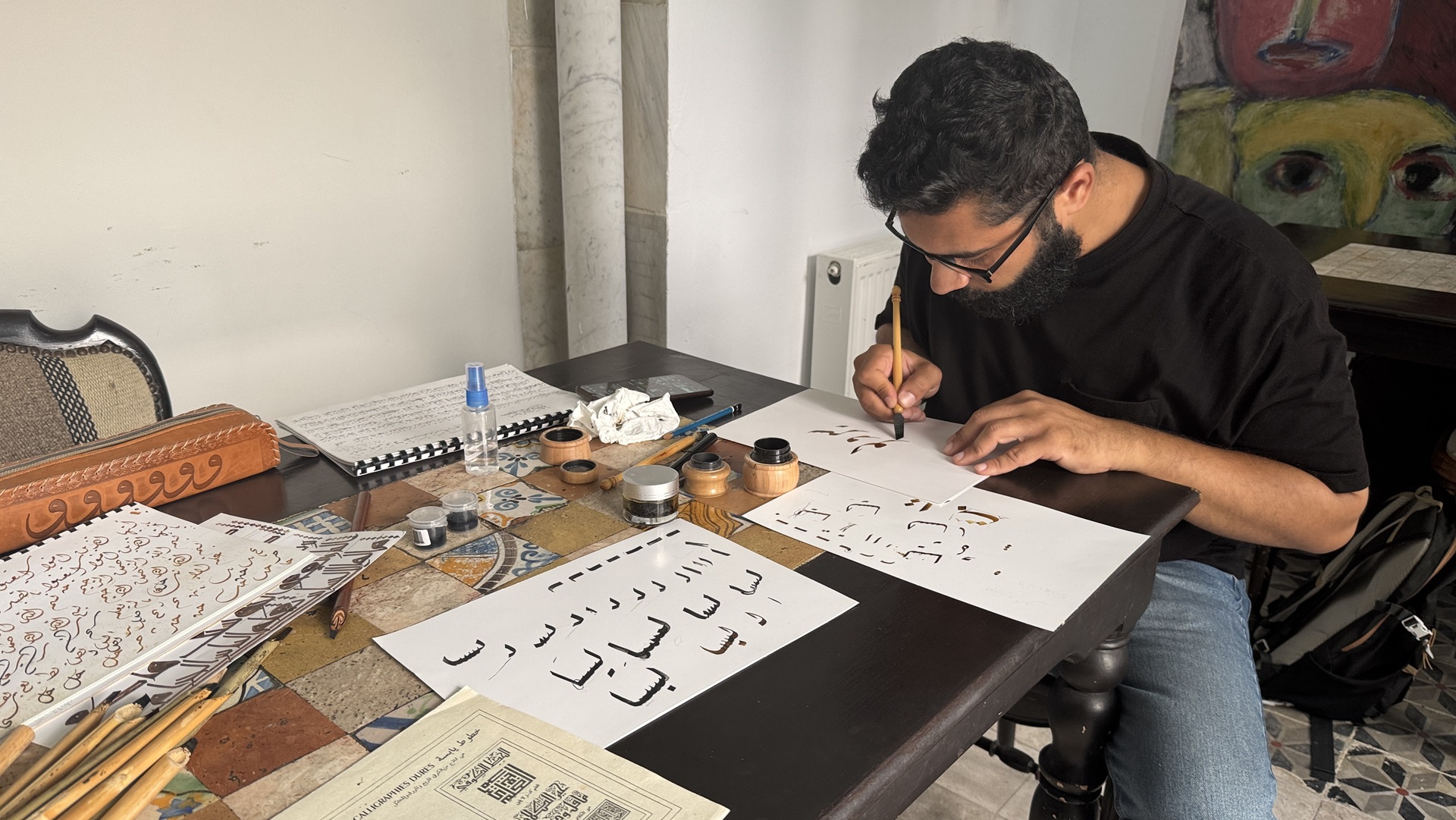 A man practising calligraphy