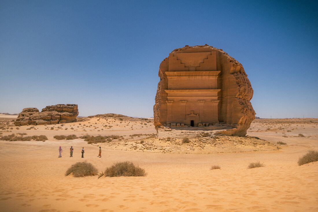 Travellers approach Qaṣr al-Farīd, the largest monument in Hegra, a collection of over 100 carved tombs and facades dating back to the 1st Century CE