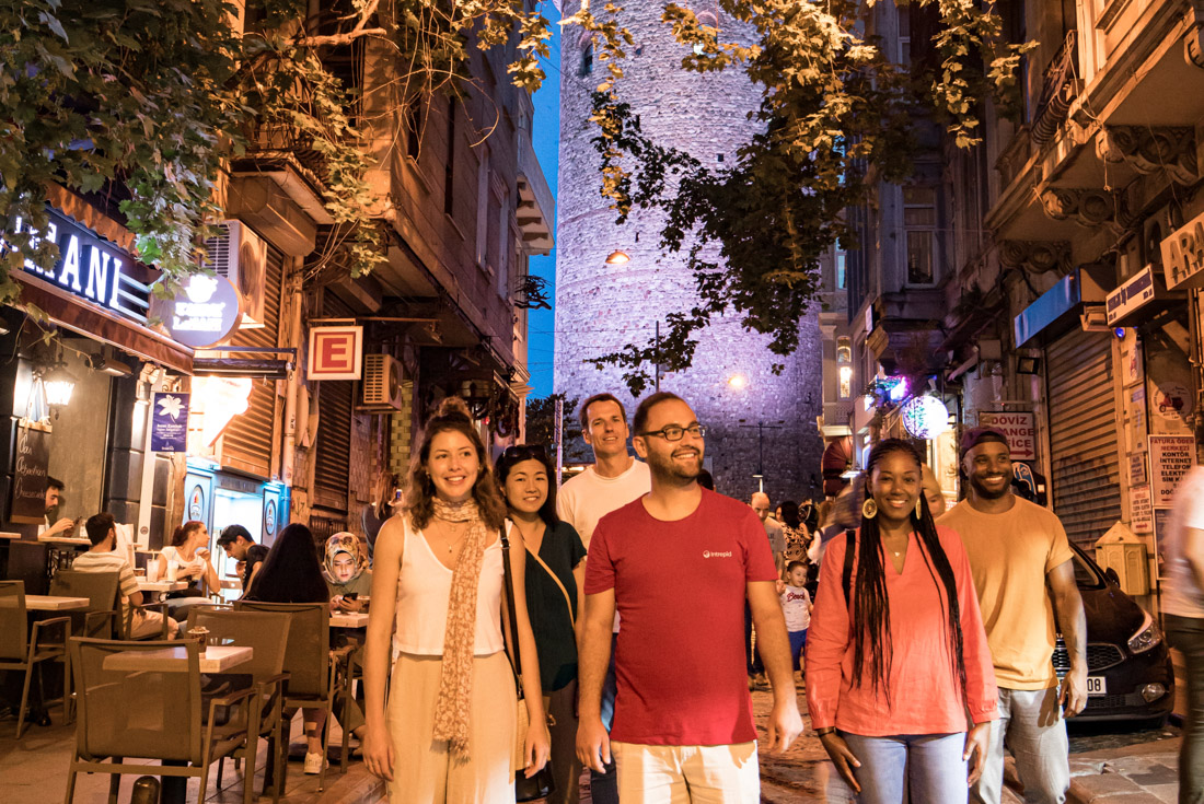 Intrepid group with leader headed by leader explore the streets of Instanbul at night