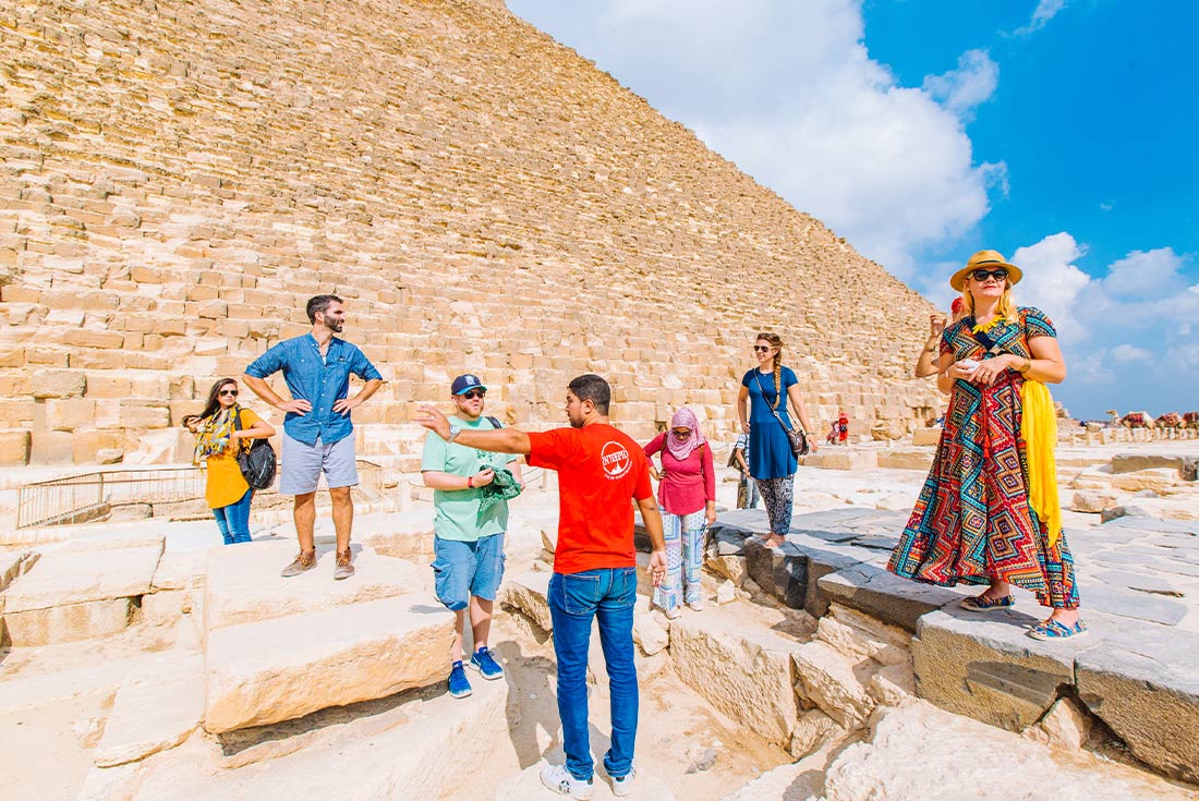 Intrepid group at the base of the pyramids, Cairo, Egypt