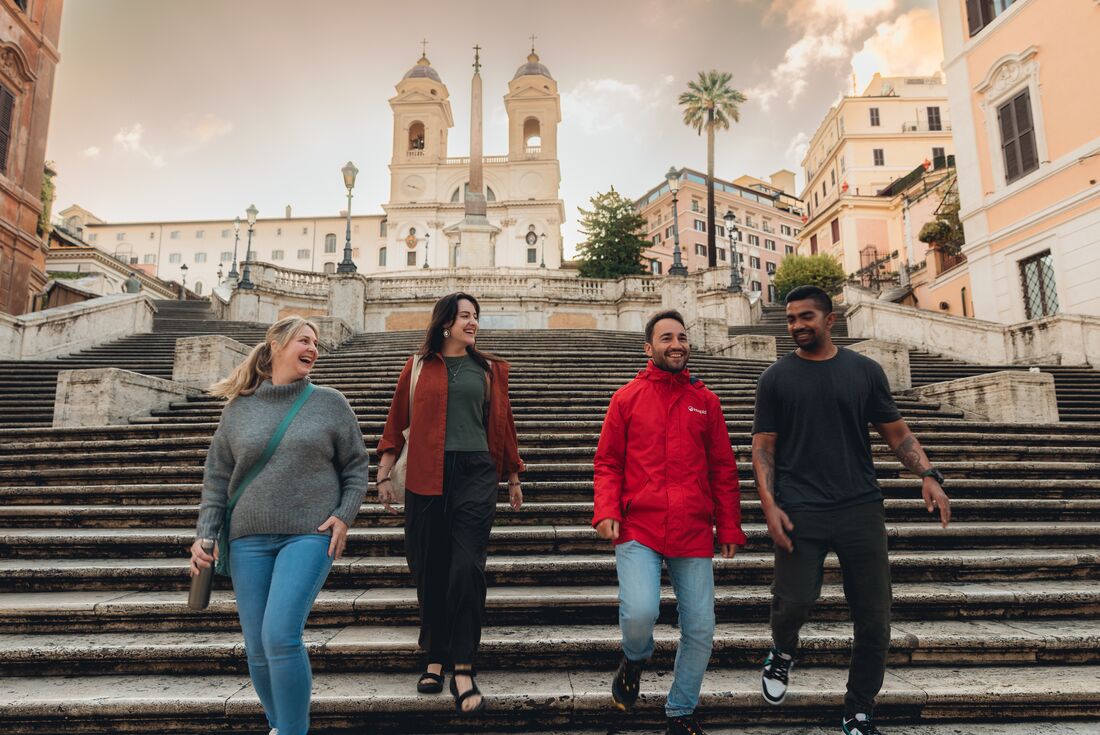 Leader and travellers walking down the Spanish Steps in Rome, Italy