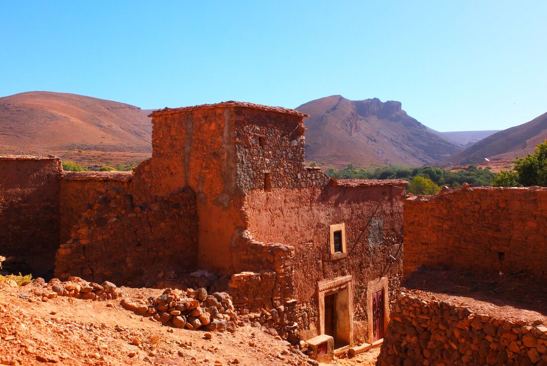 Red clay brick buildings of Tleta Tagmoute village in Morocco desert