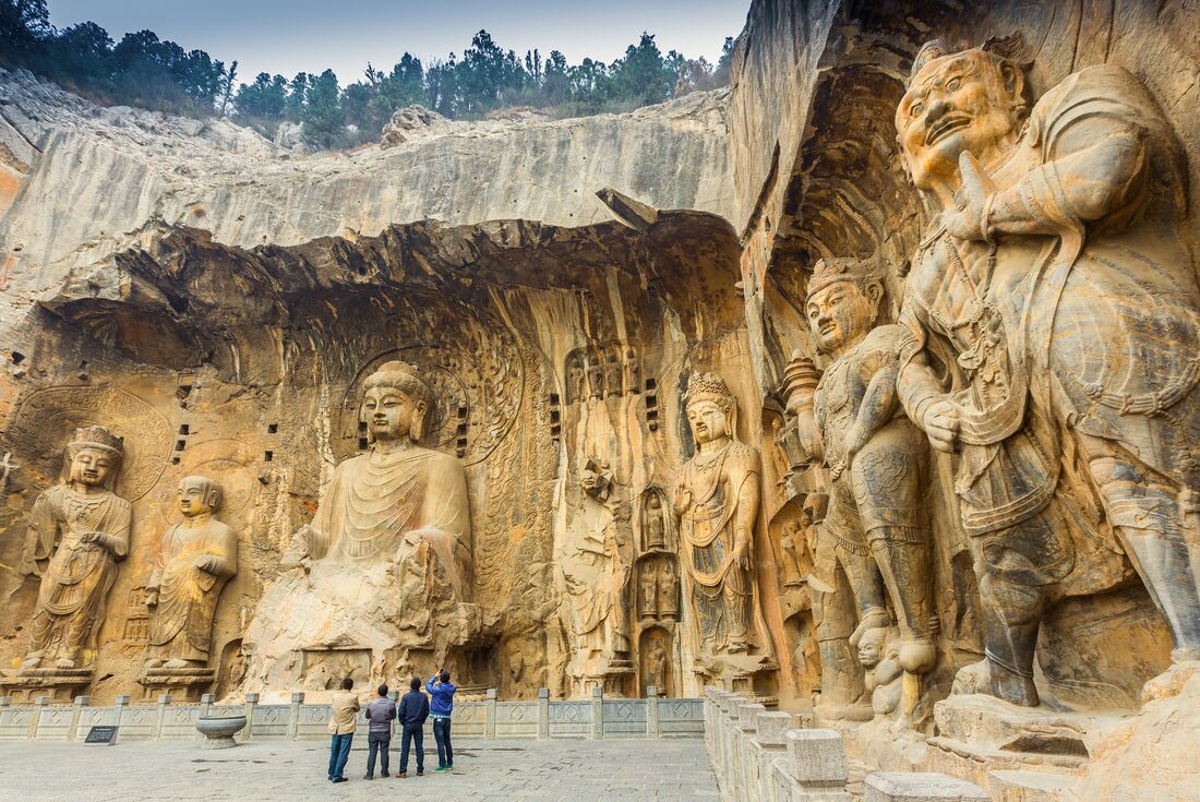 Group viewing buddah statues at Longmen grottoes, China
