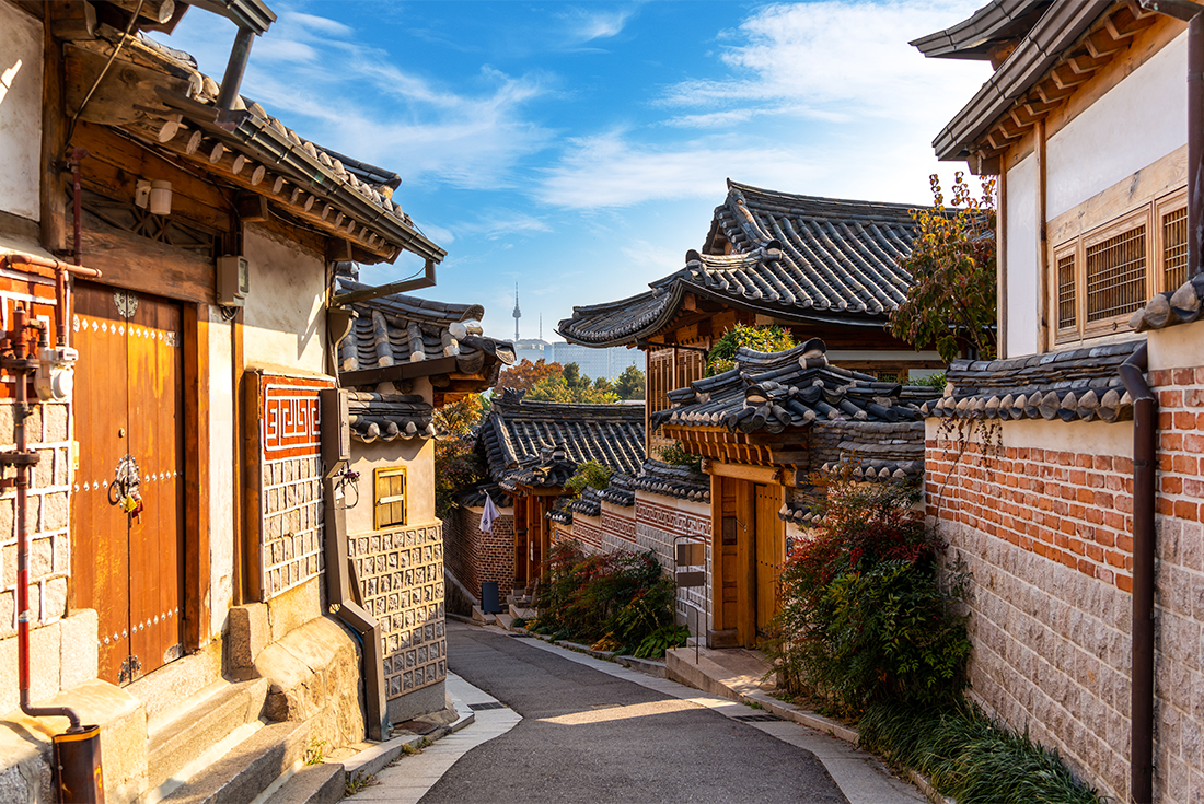 The streets of Hanok village at sunset with Seoul Tower in the distance