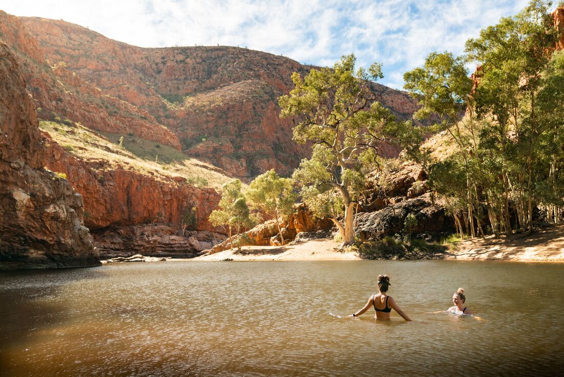 Travellers take a swim at Ormiston Gorge in Northern Territory Australia