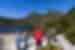 Group standing on the shores of Lake St. Clair looking up Cradle Mountain in Tasmania
