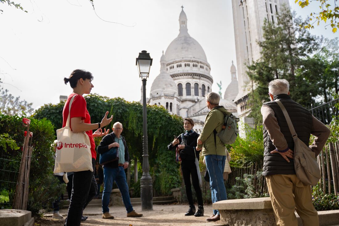 Leader talking to travellers at Sacre Coeur in Paris, France
