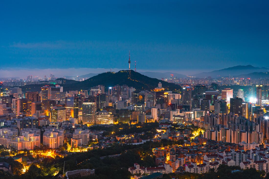 Seoul city lights at twilight with Namsan Mountain and N Seoul Tower on the skyline