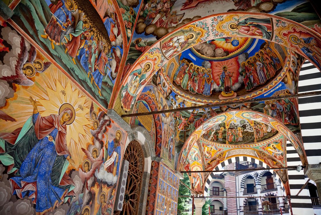 Religious murals adorn every surface of Rila Monastery's main church in Bulgaria