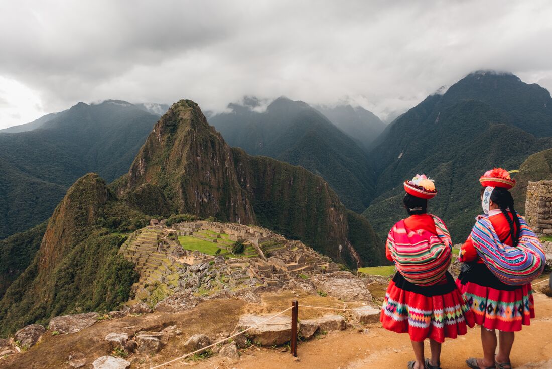 Two women from Sacred Valley community looking out at Machu Picchu for the first time