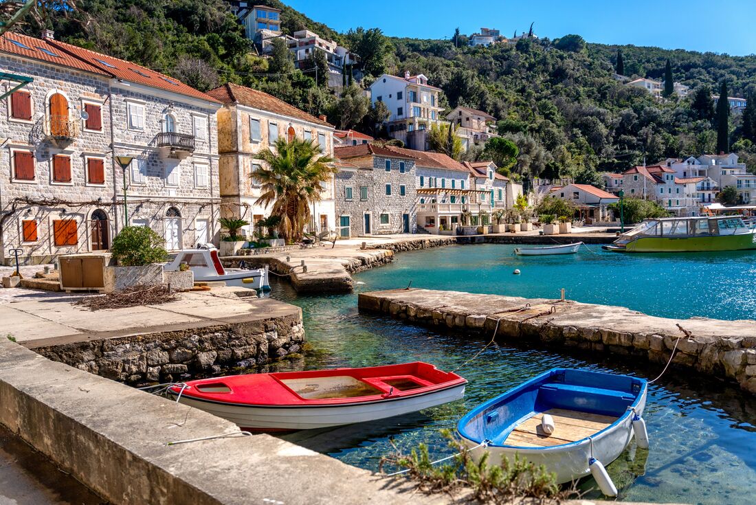 Waterfront of Rose, Montenegro with boats anchored in the marina