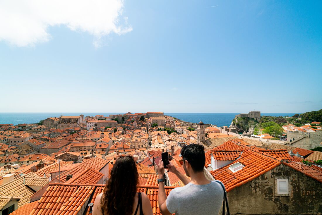 Intrepid travellers take a photo looking out over Dubrovnik Oldtown in Croatia