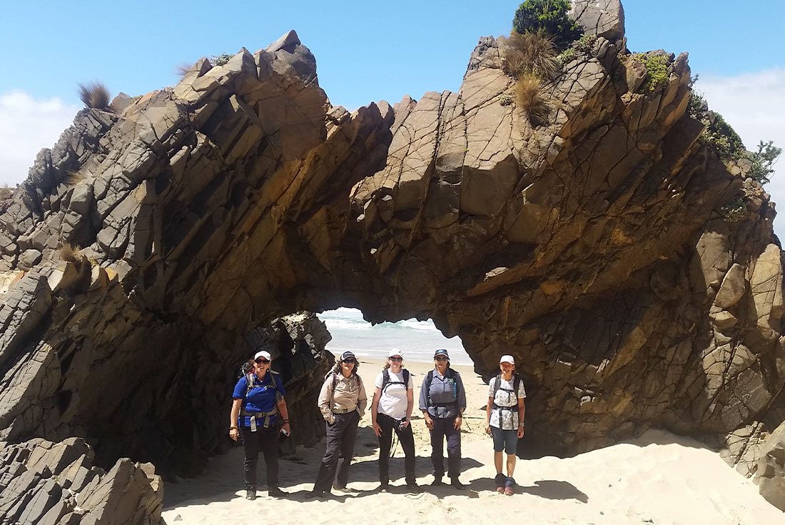 Group walking along Cape Queen Elizabeth, Bruny Island, Tasmania