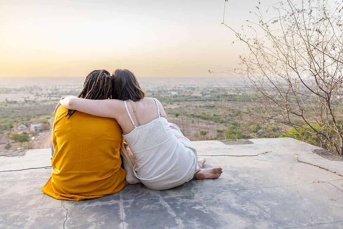 Travellers watching sunset with Tordi Garh in the background 